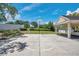 Outdoor basketball court on sunny day features a white backboard, surrounding greenery and paved area at 3301 Haviland Ct # 301, Palm Harbor, FL 34684