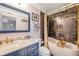 Stylish bathroom with a marble vanity, navy cabinets, and a freestanding tub at 3301 Haviland Ct # 301, Palm Harbor, FL 34684