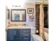 Chic bathroom with marble vanity, navy cabinets, and a floral shower curtain at 3301 Haviland Ct # 301, Palm Harbor, FL 34684