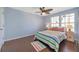 Cozy bedroom with wood floors, ceiling fan, and lots of natural light at 3301 Haviland Ct # 301, Palm Harbor, FL 34684