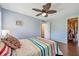 Bedroom features a ceiling fan, wood floors, and closet at 3301 Haviland Ct # 301, Palm Harbor, FL 34684