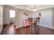 Dining area with a glass table set and a decorative pink buffet near the stairway at 3301 Haviland Ct # 301, Palm Harbor, FL 34684