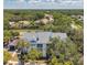 Beautiful condo featuring white exterior and gray roof, nestled among trees in lush landscaping at 3301 Haviland Ct # 301, Palm Harbor, FL 34684