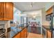 Open kitchen view showcasing stainless appliances, granite counters, and adjacent dining area at 3301 Haviland Ct # 301, Palm Harbor, FL 34684