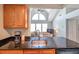 Open-concept kitchen featuring granite counters, modern appliances, and vaulted ceilings at 3301 Haviland Ct # 301, Palm Harbor, FL 34684