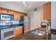Well-lit kitchen with stainless steel appliances, granite countertops, and wood cabinetry at 3301 Haviland Ct # 301, Palm Harbor, FL 34684