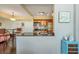 Open kitchen featuring stainless steel appliances and a bar overlooking the dining area at 3301 Haviland Ct # 301, Palm Harbor, FL 34684