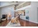 Open concept living room with high ceilings, a loft, hardwood floors, and views into the kitchen at 3301 Haviland Ct # 301, Palm Harbor, FL 34684