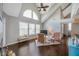 Bright living room featuring hardwood floors, vaulted ceilings, large windows, and ceiling fan at 3301 Haviland Ct # 301, Palm Harbor, FL 34684