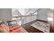 Bright loft space with wood floors and a railing overlooking the floor below at 3301 Haviland Ct # 301, Palm Harbor, FL 34684