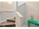 Bright staircase with wooden steps, white handrails, and a green accent table at 3301 Haviland Ct # 301, Palm Harbor, FL 34684