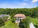 Expansive property showcasing a lush lawn, mature trees, and a charming patio area at 3500 Ballastone Dr, Land O Lakes, FL 34638
