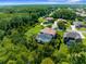 Gorgeous aerial view of the screened in pool and landscaped yard surrounded by lush greenery at 3500 Ballastone Dr, Land O Lakes, FL 34638