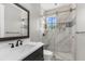 Bathroom featuring a glass walk-in shower, marble tiling, and modern fixtures at 3500 Ballastone Dr, Land O Lakes, FL 34638