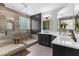 Elegant bathroom with a glass shower enclosure and a double vanity with modern fixtures at 3500 Ballastone Dr, Land O Lakes, FL 34638