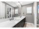 Spacious bathroom with a double vanity, large mirror and a view of the shower and toilet room at 3500 Ballastone Dr, Land O Lakes, FL 34638