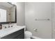 Well-lit bathroom featuring a modern vanity, toilet, and shower with neutral color palette at 3500 Ballastone Dr, Land O Lakes, FL 34638