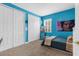Bright bedroom featuring blue walls, a double closet, and carpet flooring throughout at 3500 Ballastone Dr, Land O Lakes, FL 34638