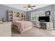 Inviting bedroom with a built-in bookcase, a bed, and a desk for working from home at 3500 Ballastone Dr, Land O Lakes, FL 34638