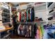 Bright walk-in closet with custom shelving and racks providing ample storage space for clothes and accessories at 3500 Ballastone Dr, Land O Lakes, FL 34638