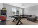 Spacious game room featuring a foosball table, comfortable sectional sofa, and natural light from large windows at 3500 Ballastone Dr, Land O Lakes, FL 34638