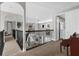Second story hallway overlooking the living area with carpet flooring and neutral paint at 3500 Ballastone Dr, Land O Lakes, FL 34638