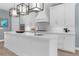 Modern kitchen with white cabinets, an island, and pendant lighting at 3500 Ballastone Dr, Land O Lakes, FL 34638