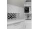 Kitchenette area with custom backsplash and wine storage at 3500 Ballastone Dr, Land O Lakes, FL 34638
