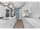 Spacious kitchen showcasing white cabinetry, quartz countertops, and modern lighting fixtures at 3500 Ballastone Dr, Land O Lakes, FL 34638