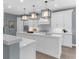 Modern kitchen with white cabinets, an island, and pendant lighting at 3500 Ballastone Dr, Land O Lakes, FL 34638