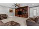 Spacious living room featuring custom built-ins and comfortable leather seating at 3500 Ballastone Dr, Land O Lakes, FL 34638