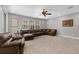 Comfortable living room features a large window and a plush brown leather sectional sofa at 3500 Ballastone Dr, Land O Lakes, FL 34638