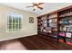 Bright home office featuring built-in bookshelves and ample workspace for productivity at 3500 Ballastone Dr, Land O Lakes, FL 34638