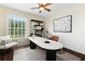 Bright office space featuring a large window, modern desk, and stylish decor for a productive workspace at 3500 Ballastone Dr, Land O Lakes, FL 34638