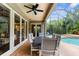 Inviting outdoor patio with a dining table, seating, and a view of the pool area at 3500 Ballastone Dr, Land O Lakes, FL 34638