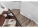 Carpeted staircase leading to the lower level, complemented by a cozy seating area with sofa and pillows at 3500 Ballastone Dr, Land O Lakes, FL 34638