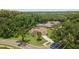 An aerial shot showcasing a home with a screened-in pool, surrounded by lush greenery and neighborhood homes at 3509 Country Creek Ln, Valrico, FL 33596