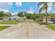 A home exterior featuring a driveway, well-maintained lawn, and view of the side of the house at 3509 Country Creek Ln, Valrico, FL 33596