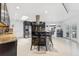 Modern kitchen with dark cabinets, granite countertops, stainless steel appliances, and an island with bar seating at 3509 Country Creek Ln, Valrico, FL 33596