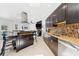 Bright kitchen with stainless steel appliances, mosaic backsplash, a central island, and an open floorplan at 3509 Country Creek Ln, Valrico, FL 33596
