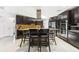 Modern kitchen boasts dark wood cabinetry, stainless steel appliances, and a central island with bar seating at 3509 Country Creek Ln, Valrico, FL 33596