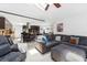 Open-concept living room and kitchen with a comfortable sectional sofa and a center island with bar stools at 3509 Country Creek Ln, Valrico, FL 33596
