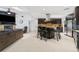Open concept living space featuring a modern kitchen, cozy fireplace, and comfortable seating area at 3509 Country Creek Ln, Valrico, FL 33596