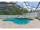 A screened-in pool area with a uniquely shaped pool, brick pavers, and small spa for luxurious outdoor living at 3509 Country Creek Ln, Valrico, FL 33596