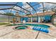 Screened-in pool area boasting a spa, uniquely shaped pool, and ample deck space, perfect for Florida living at 3509 Country Creek Ln, Valrico, FL 33596