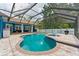 A screened-in pool area featuring a uniquely shaped pool, spa, and ample seating space perfect for entertaining at 3509 Country Creek Ln, Valrico, FL 33596