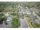 Beautiful aerial view of a house with a pool and pond in a serene, wooded neighborhood at 3603 Arbor Chase Dr, Palm Harbor, FL 34683