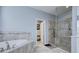 Bathroom boasts a soaking tub and glass-enclosed shower with tiled walls at 3603 Arbor Chase Dr, Palm Harbor, FL 34683