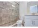 Elegant bathroom with glass-enclosed tiled shower, white vanity, and modern fixtures, creating a serene space at 3603 Arbor Chase Dr, Palm Harbor, FL 34683