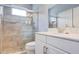 Modern bathroom with a glass shower, white vanity, and tile flooring at 3603 Arbor Chase Dr, Palm Harbor, FL 34683